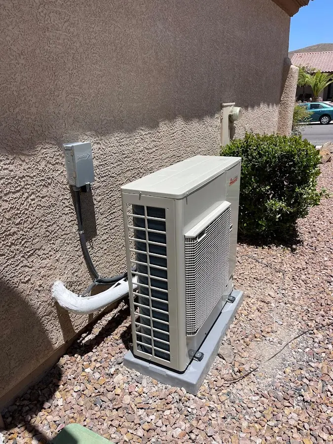 Residential air conditioning condenser unit in Brick